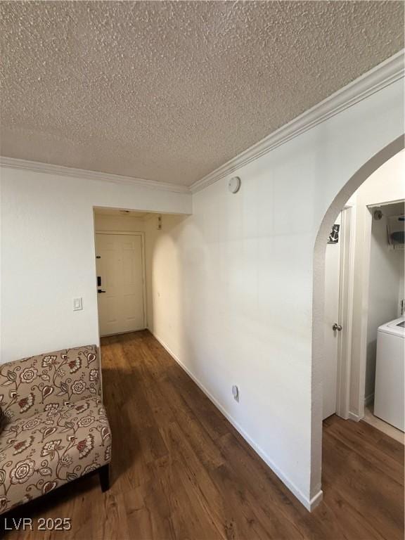 hall with crown molding, washer / dryer, a textured ceiling, and dark hardwood / wood-style flooring