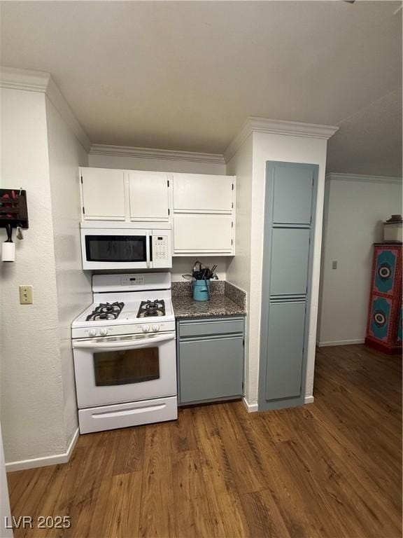 kitchen featuring white appliances, ornamental molding, dark hardwood / wood-style flooring, and white cabinets