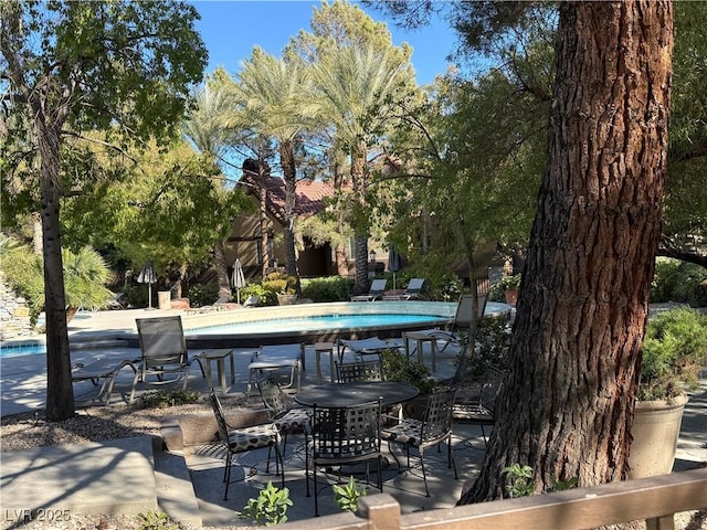 exterior space with a pool and a patio