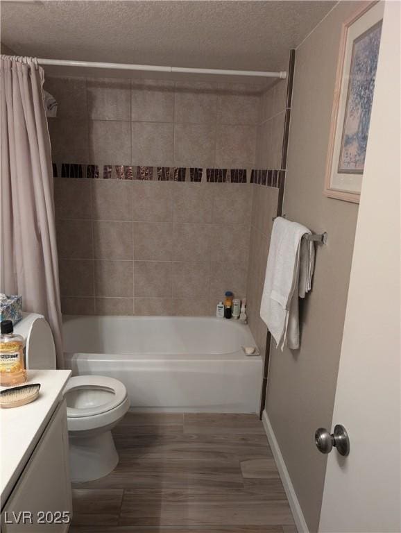 full bathroom with hardwood / wood-style flooring, shower / tub combo, vanity, a textured ceiling, and toilet