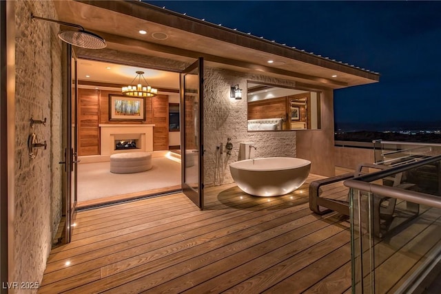 wooden deck featuring an outdoor fireplace