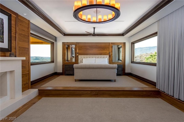 unfurnished bedroom featuring crown molding, a mountain view, and multiple windows