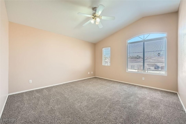 empty room featuring vaulted ceiling, ceiling fan, and carpet