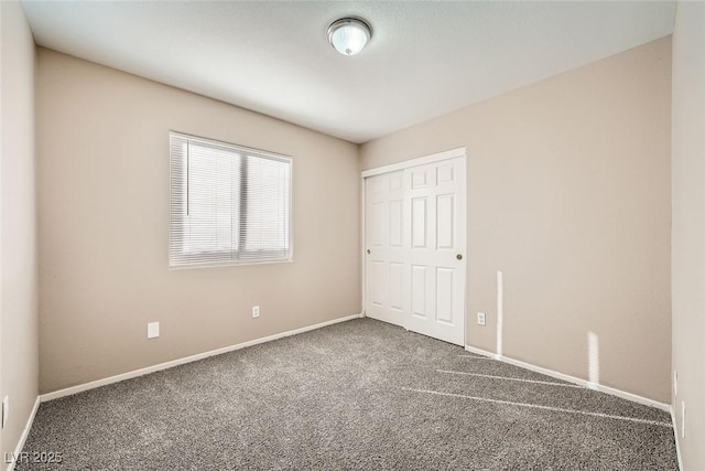 unfurnished bedroom with a closet and carpet