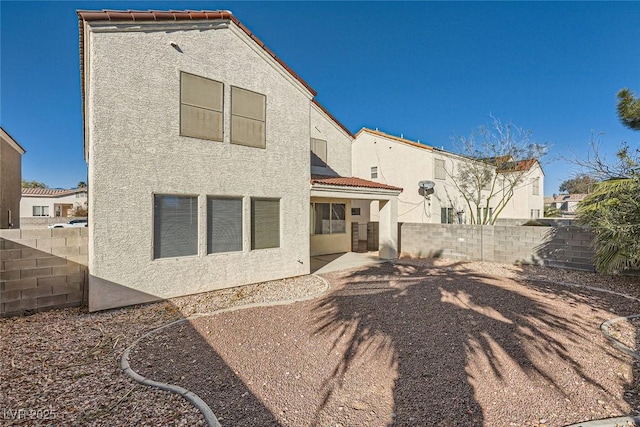 back of house with a patio