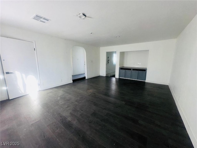 unfurnished living room featuring dark wood-type flooring