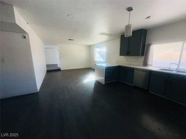 kitchen featuring hanging light fixtures, dishwasher, and sink