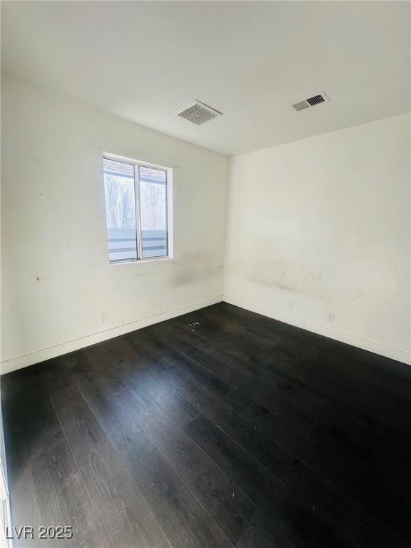 unfurnished room featuring dark hardwood / wood-style floors