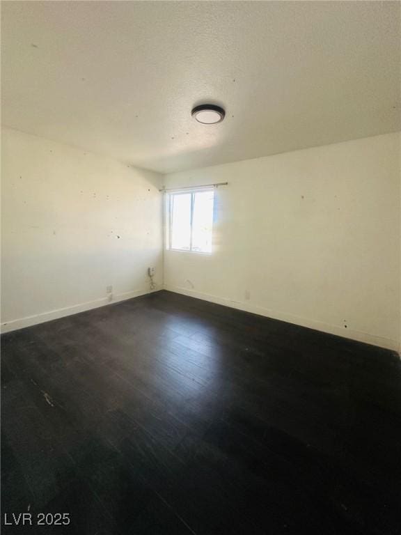 unfurnished room featuring dark hardwood / wood-style flooring