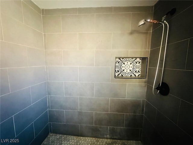 bathroom with a tile shower