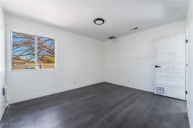 spare room featuring dark hardwood / wood-style flooring