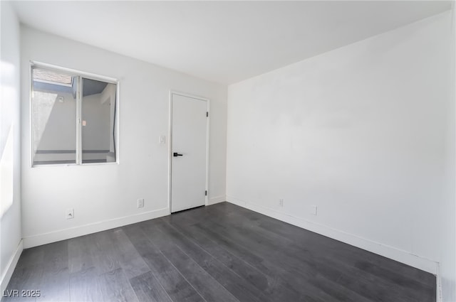 spare room featuring dark hardwood / wood-style flooring