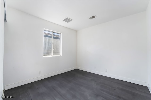 spare room with dark hardwood / wood-style flooring