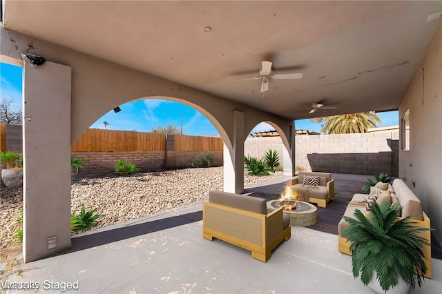 view of patio featuring an outdoor living space with a fire pit and ceiling fan