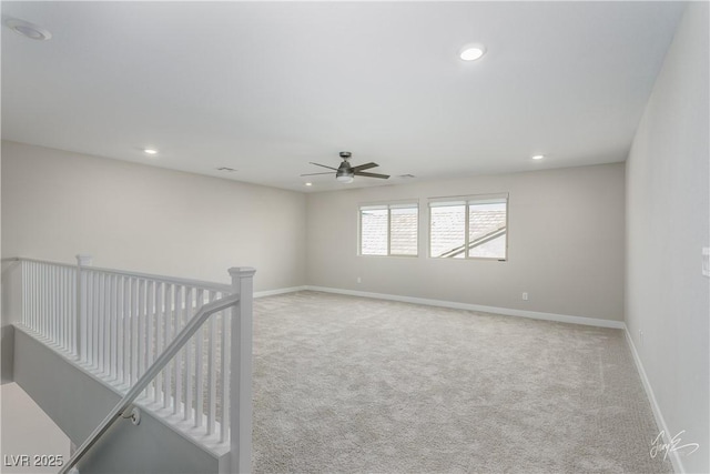 carpeted empty room featuring ceiling fan