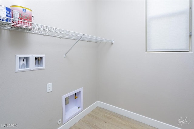 washroom with washer hookup, hardwood / wood-style floors, and hookup for a gas dryer