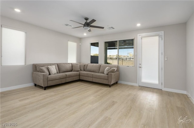 living room with ceiling fan and light wood-type flooring