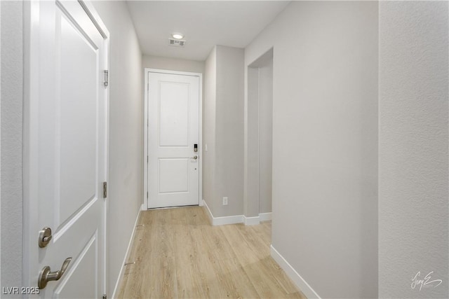 hallway with light hardwood / wood-style flooring