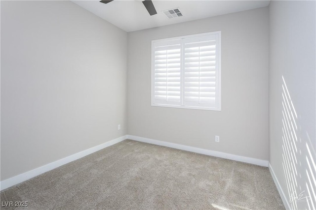 spare room with ceiling fan and light colored carpet