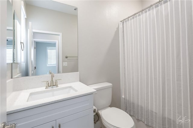 full bathroom with vanity, shower / bath combo with shower curtain, and toilet