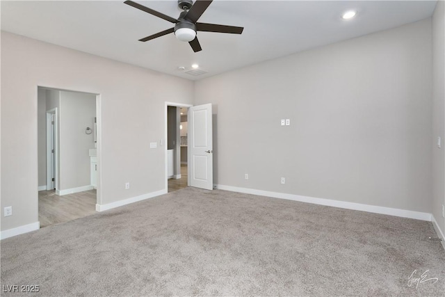 empty room featuring light carpet and ceiling fan