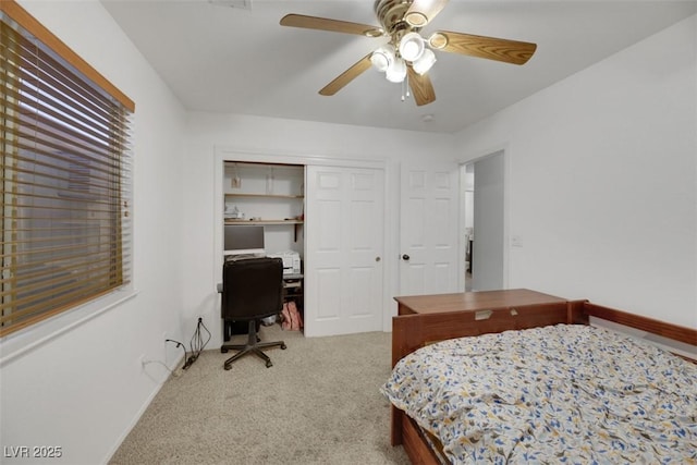 carpeted bedroom featuring ceiling fan and a closet