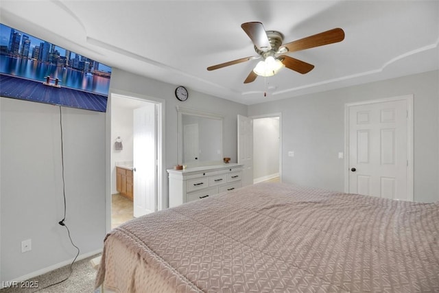 bedroom featuring ceiling fan, connected bathroom, and light carpet