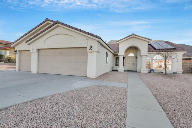 view of front of house featuring a garage and solar panels