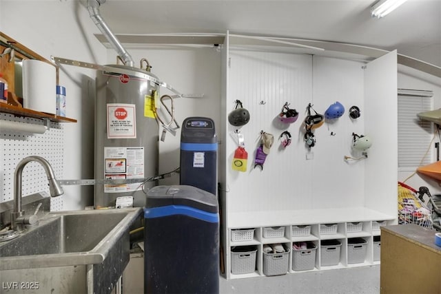 utility room featuring sink and water heater