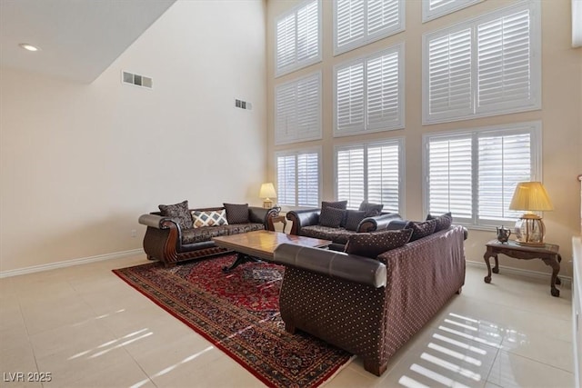 tiled living room with a towering ceiling