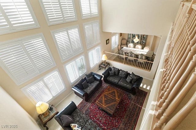 living room featuring a towering ceiling