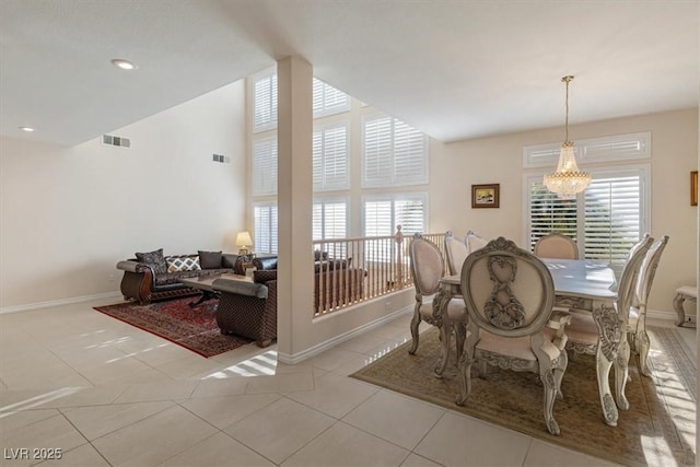 dining room featuring light tile patterned flooring and a notable chandelier