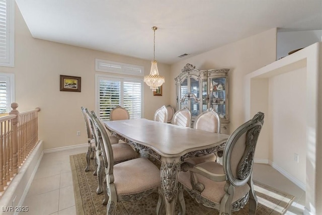 dining area with light tile patterned floors and a chandelier