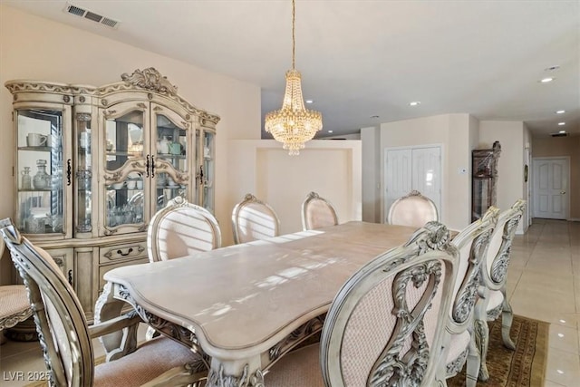 dining room with a chandelier and tile patterned flooring