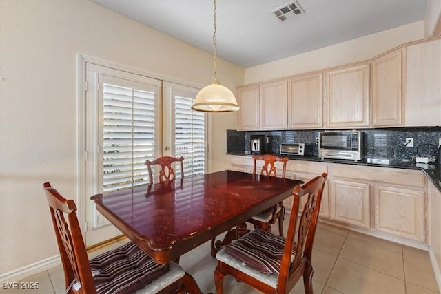 dining area featuring light tile patterned flooring