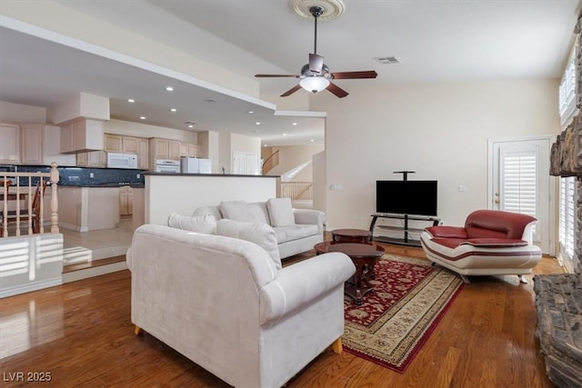 living room with hardwood / wood-style flooring and ceiling fan