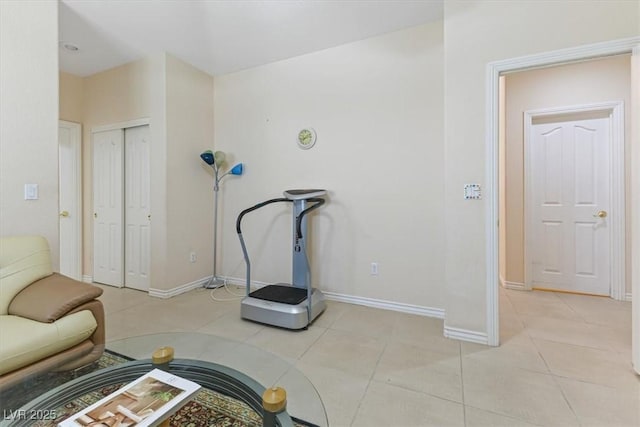 workout room featuring light tile patterned flooring