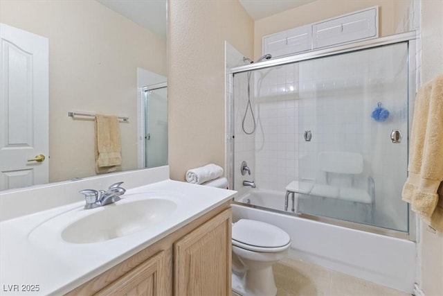 full bathroom with toilet, vanity, bath / shower combo with glass door, and tile patterned flooring