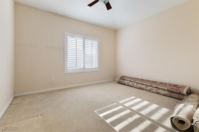 unfurnished room with ceiling fan and light colored carpet