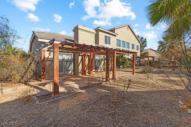 back of house with french doors and a pergola