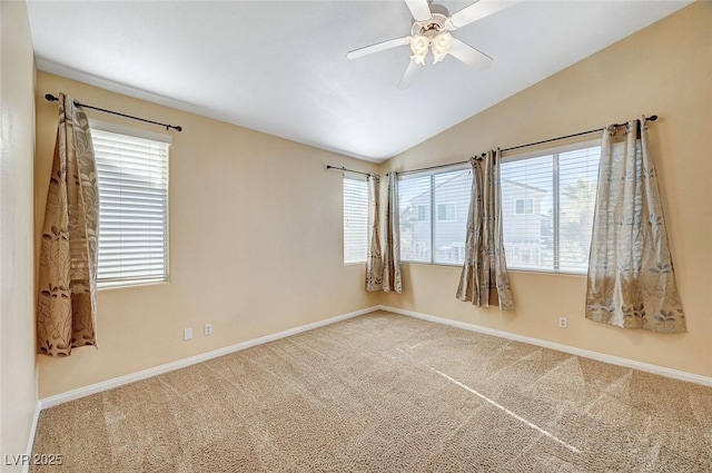 spare room with lofted ceiling, carpet, and ceiling fan