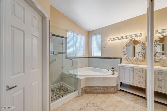 bathroom with tile patterned floors, separate shower and tub, vaulted ceiling, and vanity