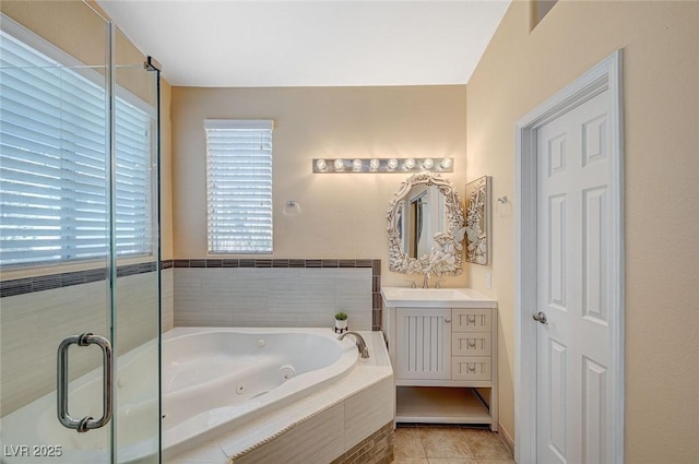 bathroom featuring tile patterned floors, vanity, and tiled tub