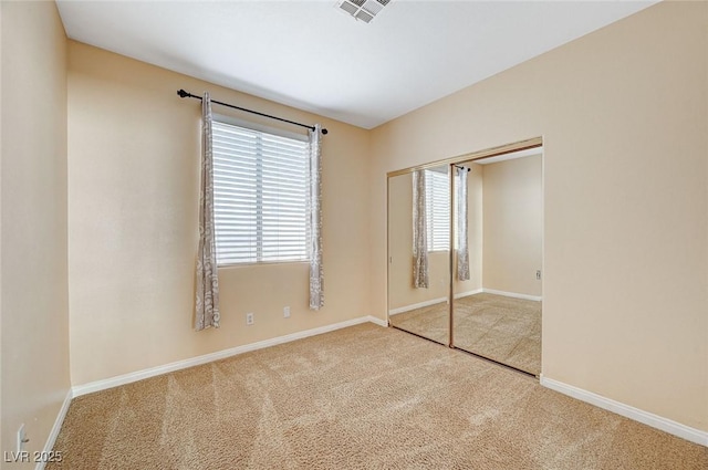 unfurnished bedroom with carpet flooring and a closet