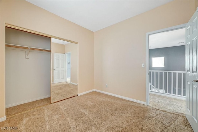 unfurnished bedroom featuring carpet flooring and a closet