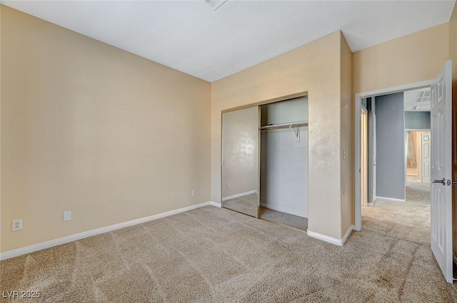 unfurnished bedroom with light carpet and a closet