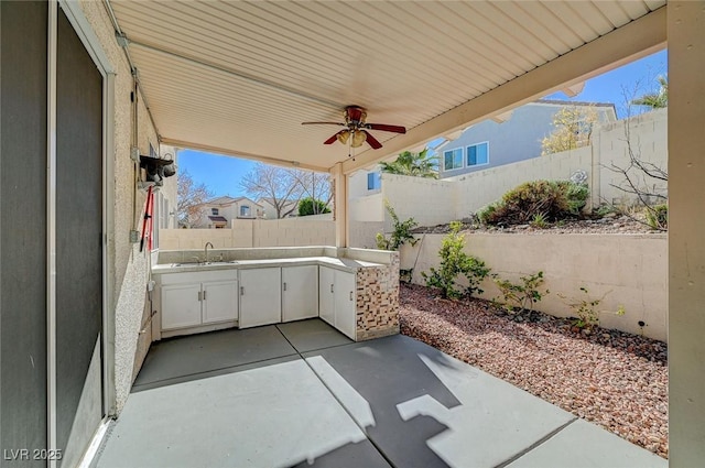 view of patio / terrace with sink and ceiling fan