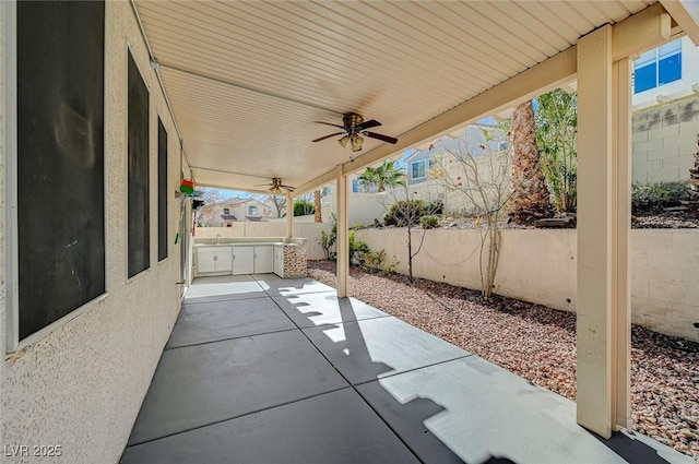 view of patio with area for grilling and ceiling fan