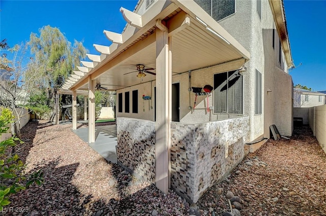 view of property exterior featuring ceiling fan and a patio area