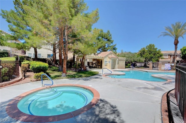 view of pool with a hot tub and a patio area